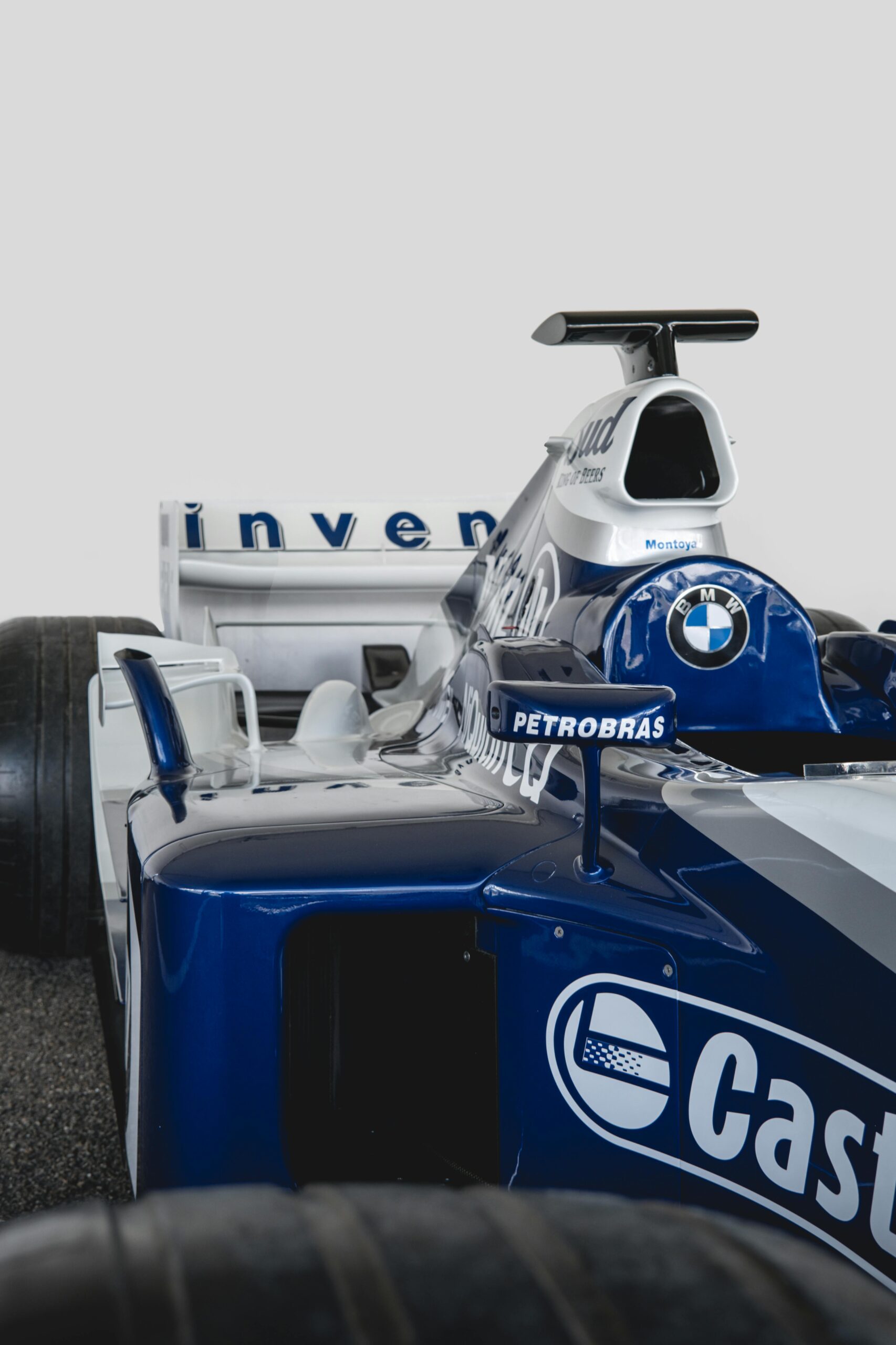 Detailed shot of a blue and white Formula 1 race car, highlighting its design and branding.